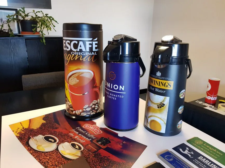 Branded airpot flask labels applied to catering coffee dispensers