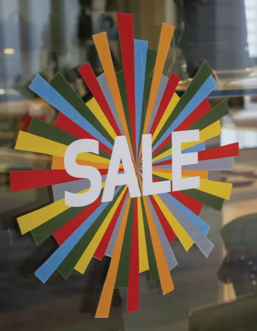 Point of sale window sticker — static cling SALE graphic in a retail window